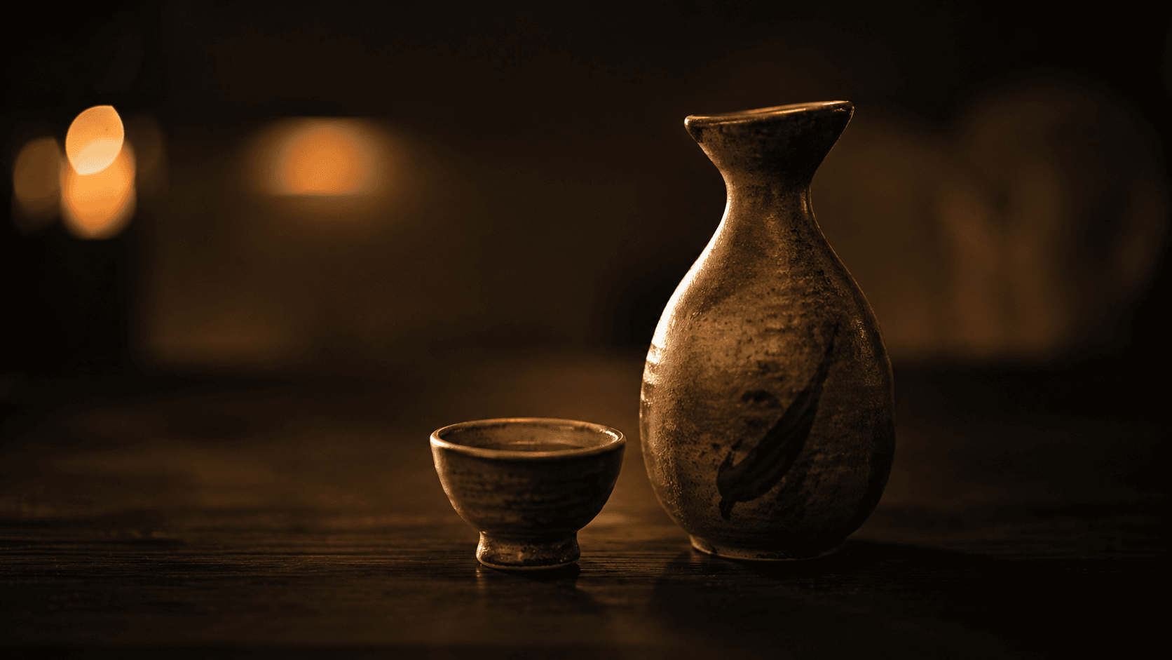 A tokkuri sake flask and cup on the counter