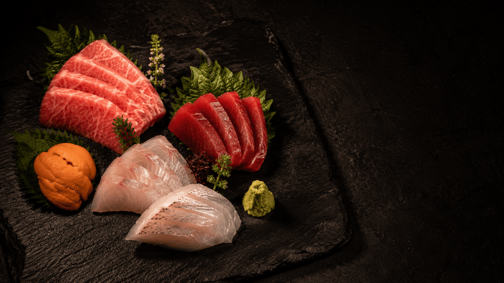 A single piece of nigiri set before a guest at the counter